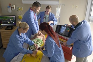 Physician assistant student practicing skills in a simulation lab.